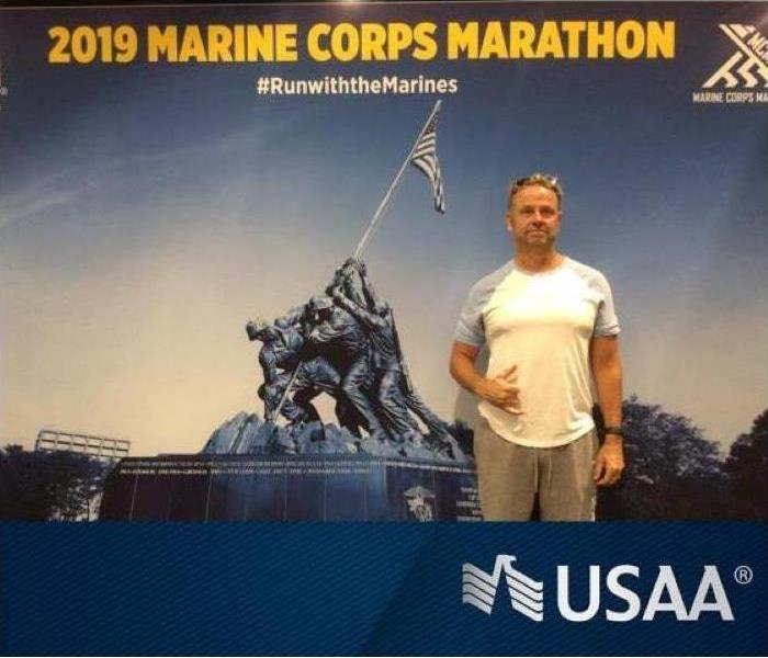 Man in front of USAA poster.