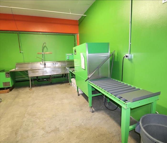 Green room with ultrasonic cleaner and steel tables.